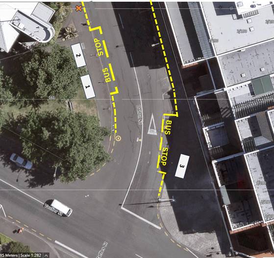 Aerial view of a road with a bus stop

Description automatically generated